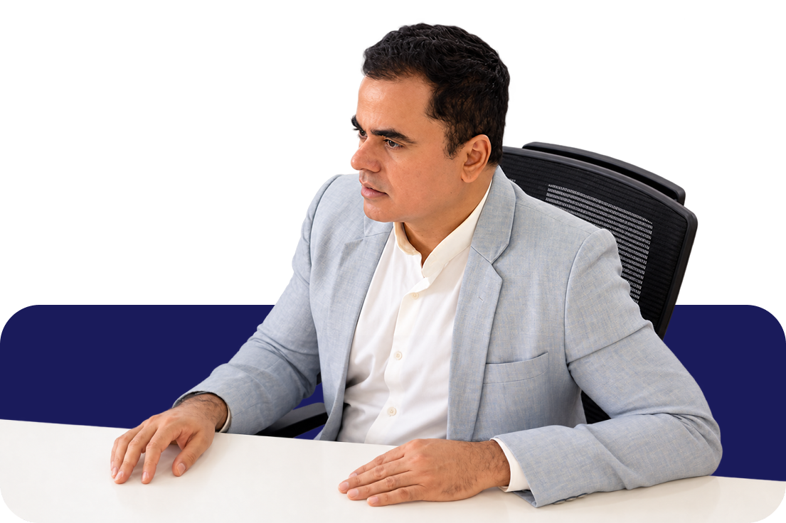 V S Ambaasuthan, Excellence Coach, seated at his desk